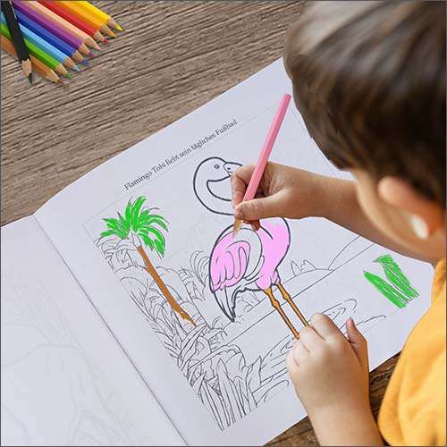 Child colours flamingo in the "Animals in the Zoo" colouring book